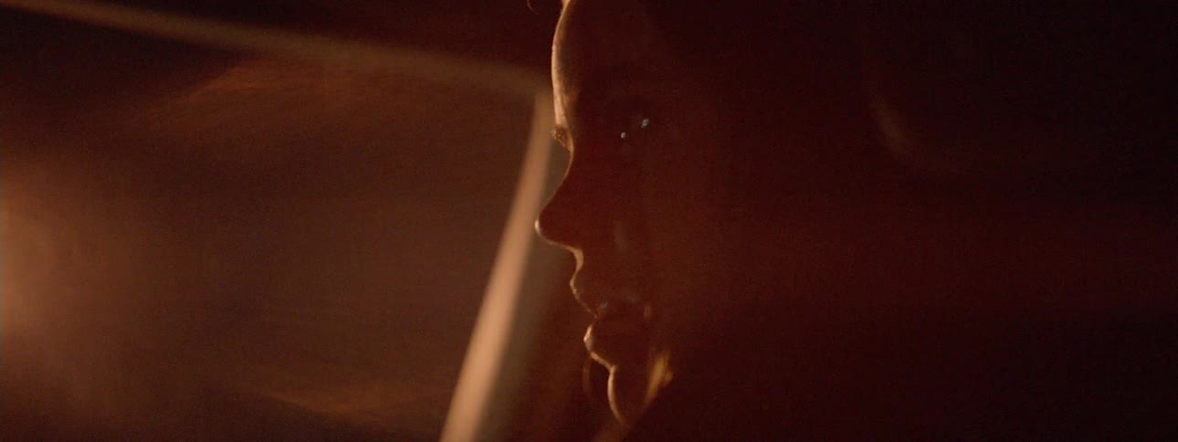 A woman is talking in the car at night