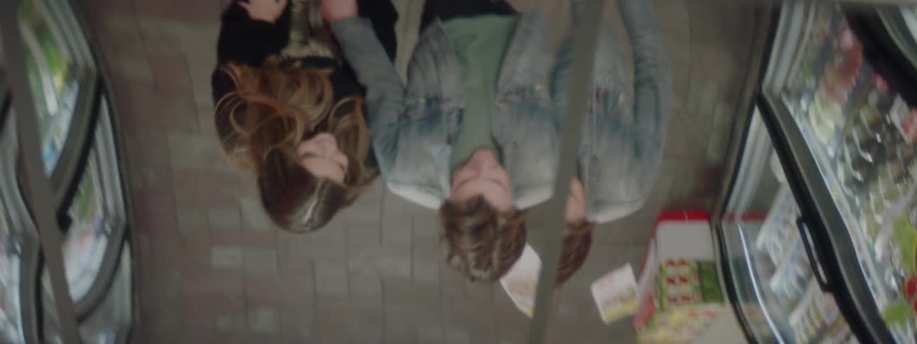Man and woman hold hands and walk in the supermarket