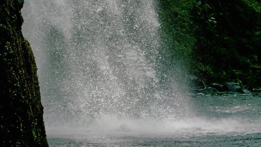 Water cascades into a natural pool