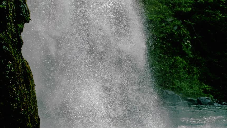 A waterfall cascading into a river below