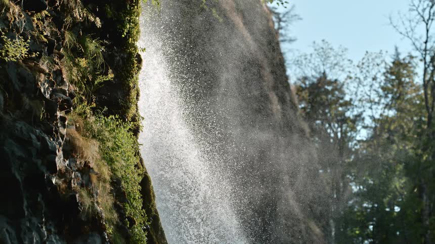 A waterfall crashes down the side of a hill