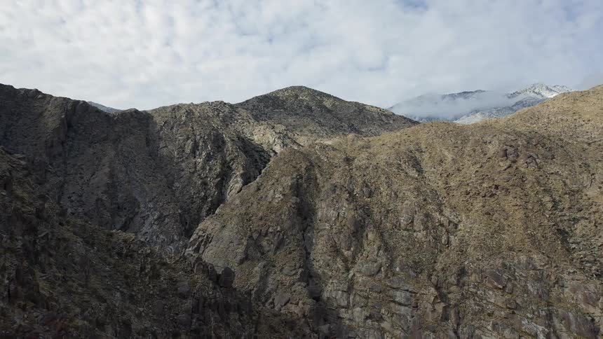 Large hills and cliffs form a vegetation covered canyon