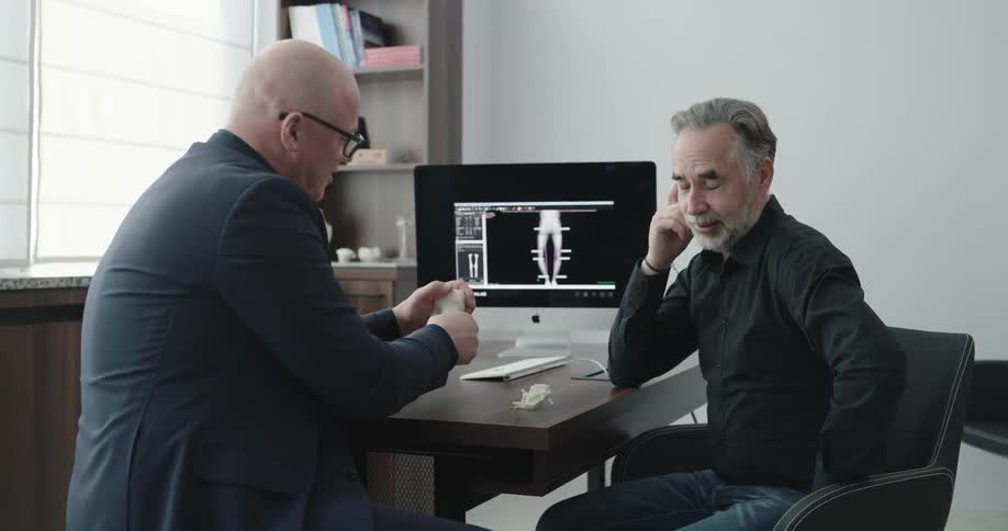 A doctor and patient talk at a desk
