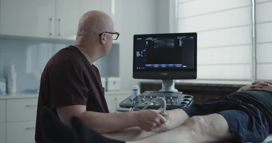 Doctor checking patient knees with a device