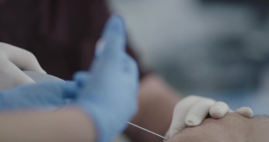 Two hospital staff work on a persons knee
