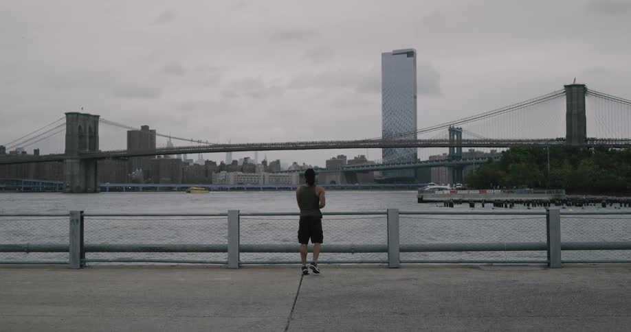 A man does does workouts near the water
