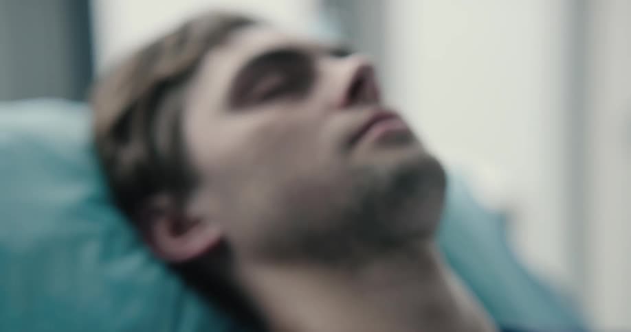 An unconscious man sleeping at the hospital room