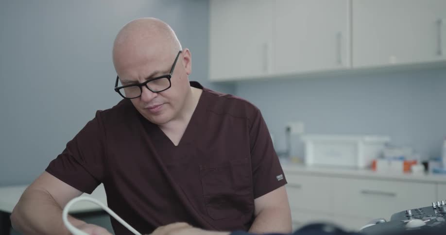 A male doctor is helping a patient using a machine