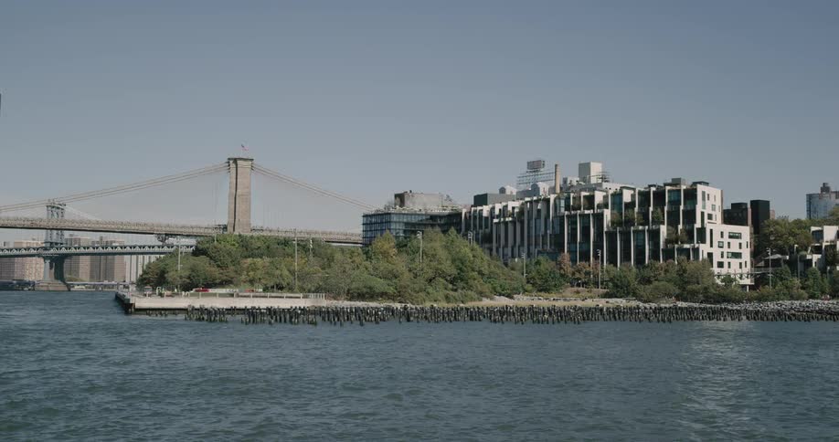 Apartment complex borders suspension bridge and ocean