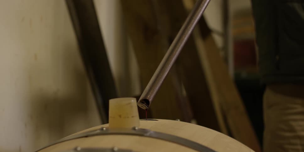 Something dripping into a barrel