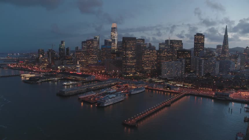 A harbor with ships with a city in the background