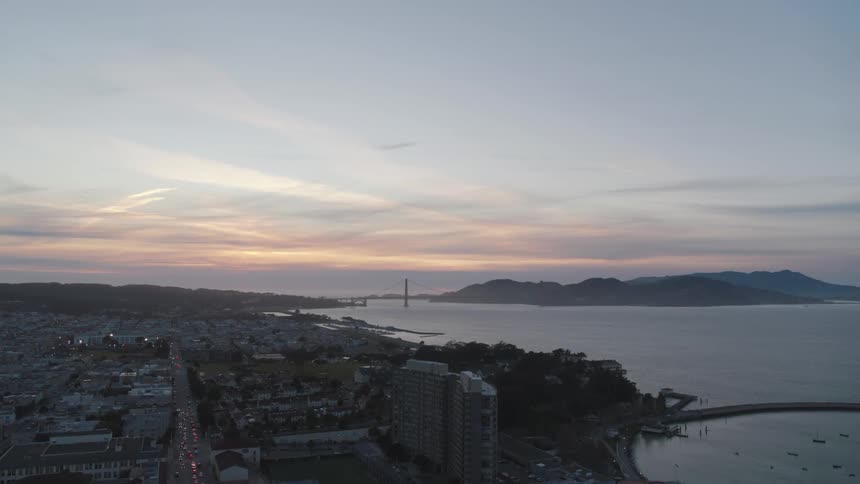 An aerial view of a city skyline at sunset