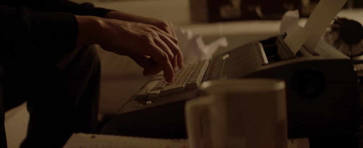 A person typing on a typewriter