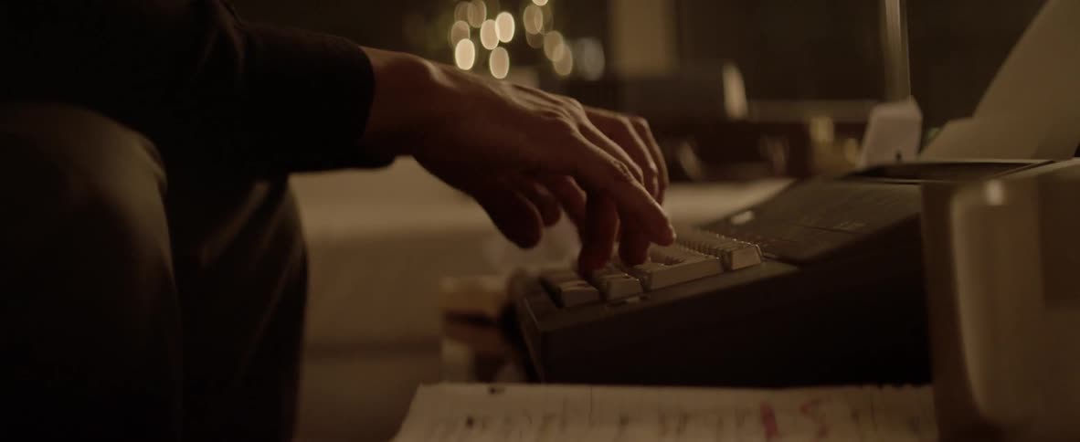 Man typing on an old keyboard