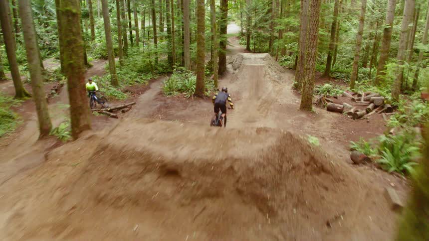 A person is doing tricks on a dirt bike outdoors