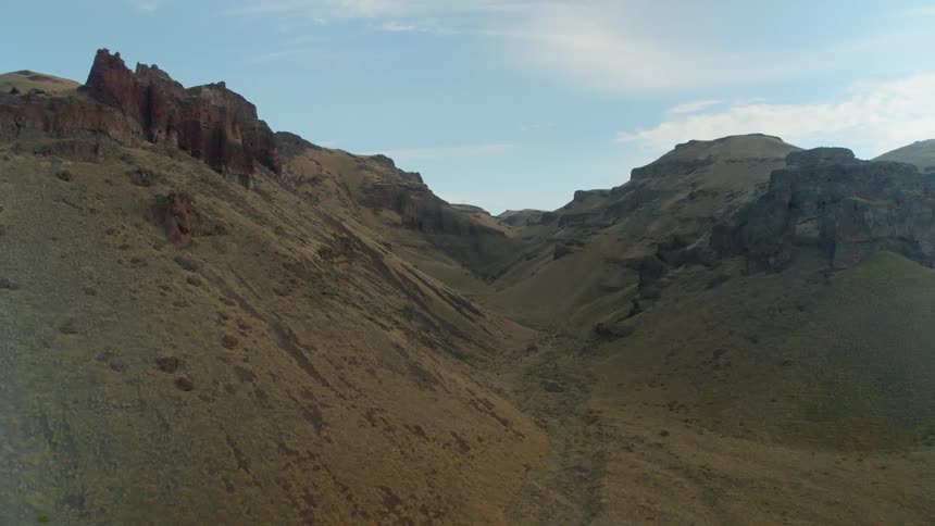 A ravine lies between mountain peaks