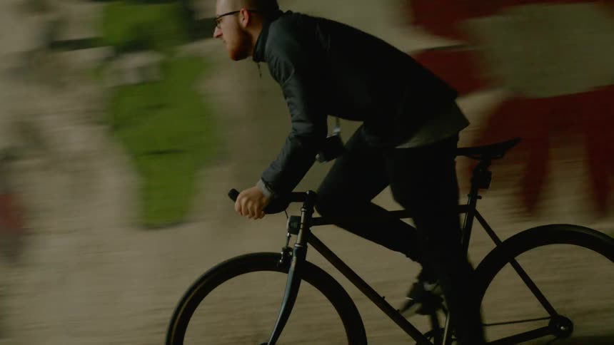 A person is riding a bike outdoors in the city