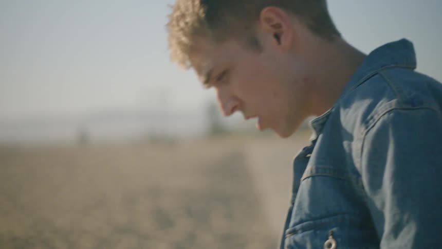 Man walks along beach thinking
