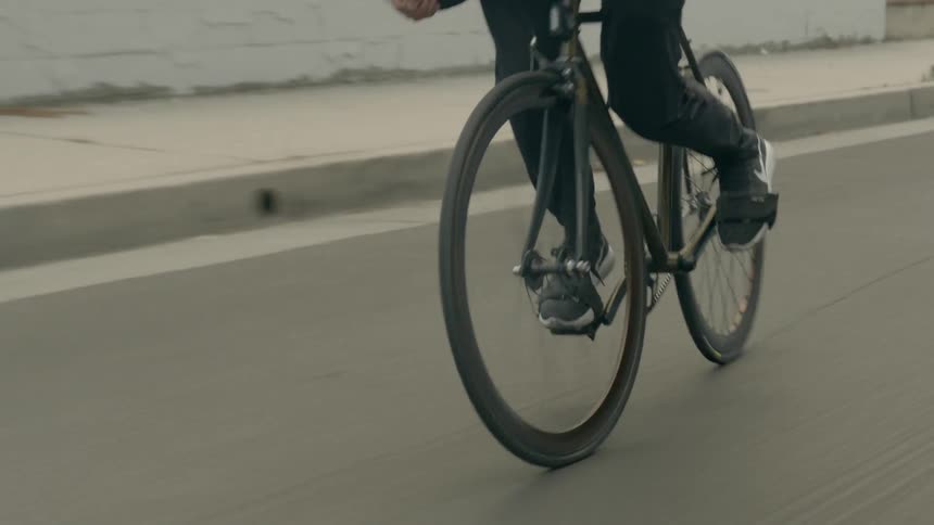 A man rides his bike down the street
