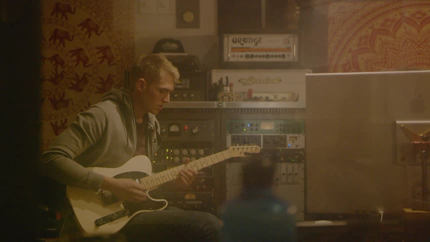 Man playing guitar at the studio