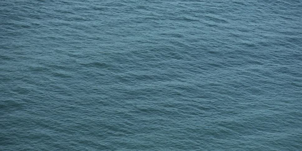 A clip above a body of water with ripples in it from the wind