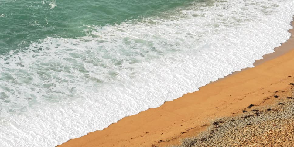 Waves crashing on a sandy beach