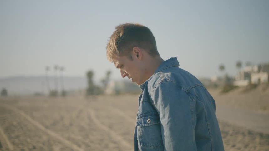 A man is walking on the beach