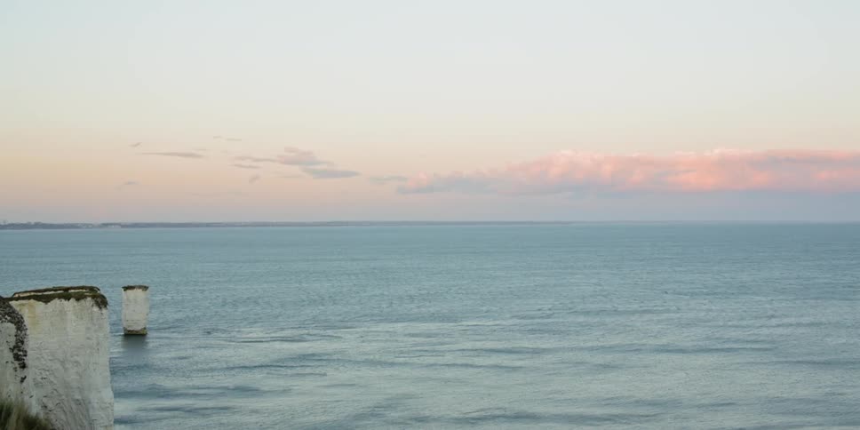 Skyline of the sun setting beyond the water
