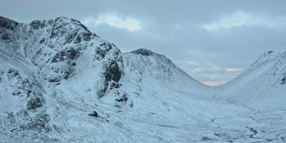 Snow covers a mountain cirque