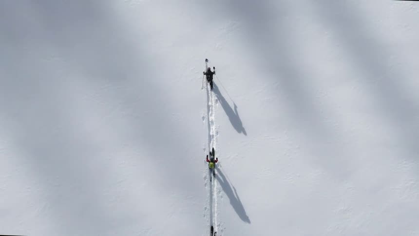 Three cross country skiers move across virgin snow