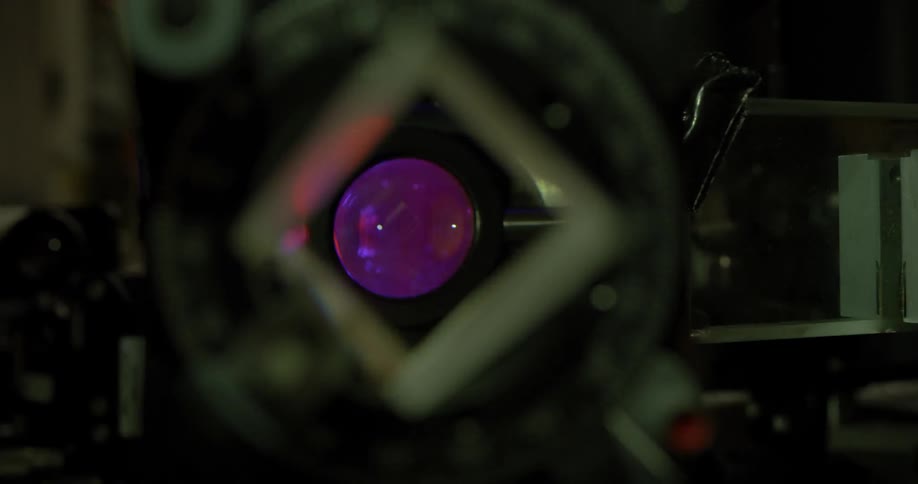 A dentist places a lens in the machine