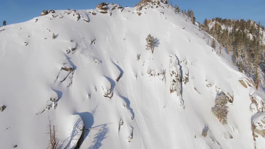 A skier goes down snow covered mountain