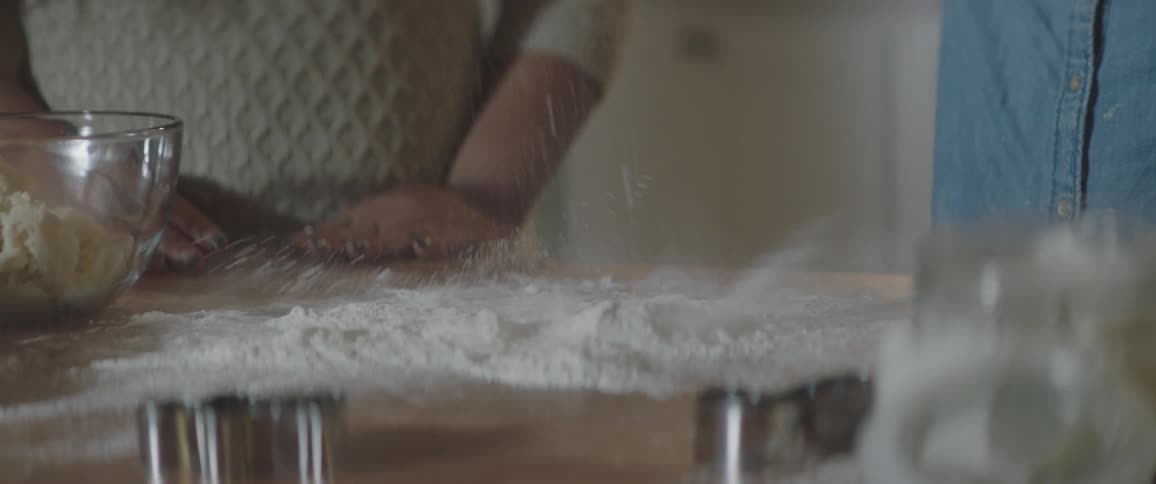 Two people are using ingredients to make food