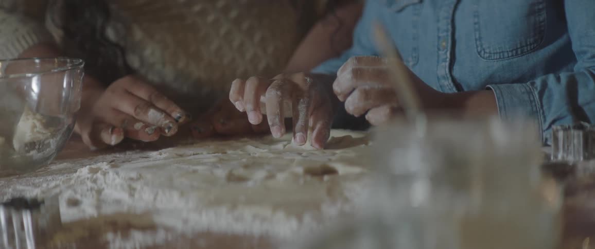 People are rolling clay in the kitchen