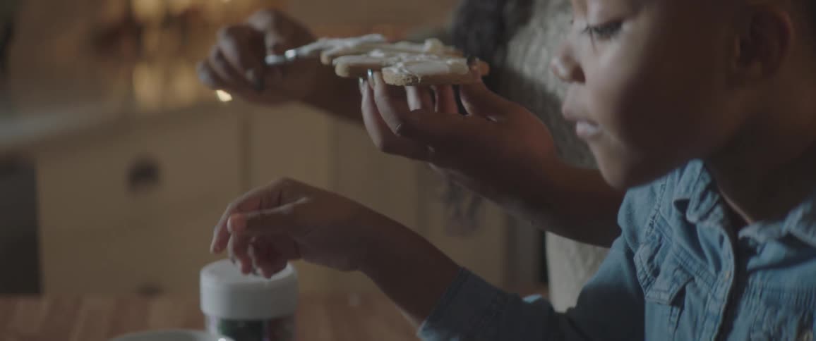 A mother and child ice cookies together