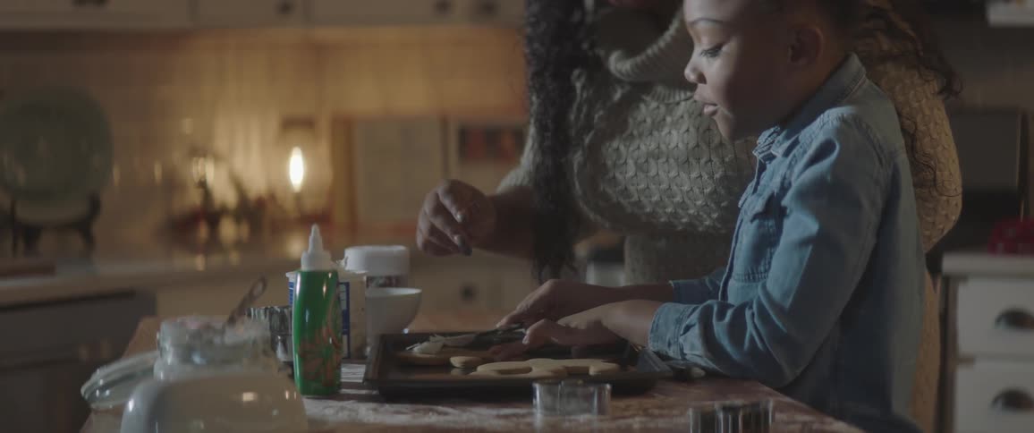 A mother and child work on baking
