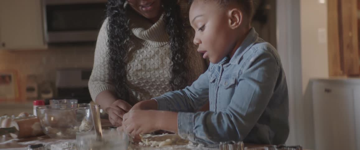 Mother and daughter cooking together