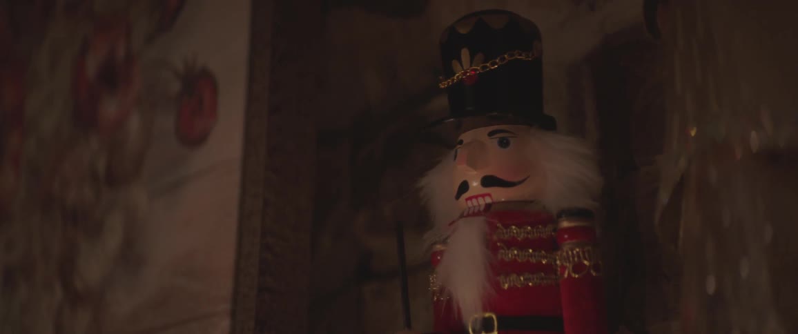 A nutcracker statue is on the shelf