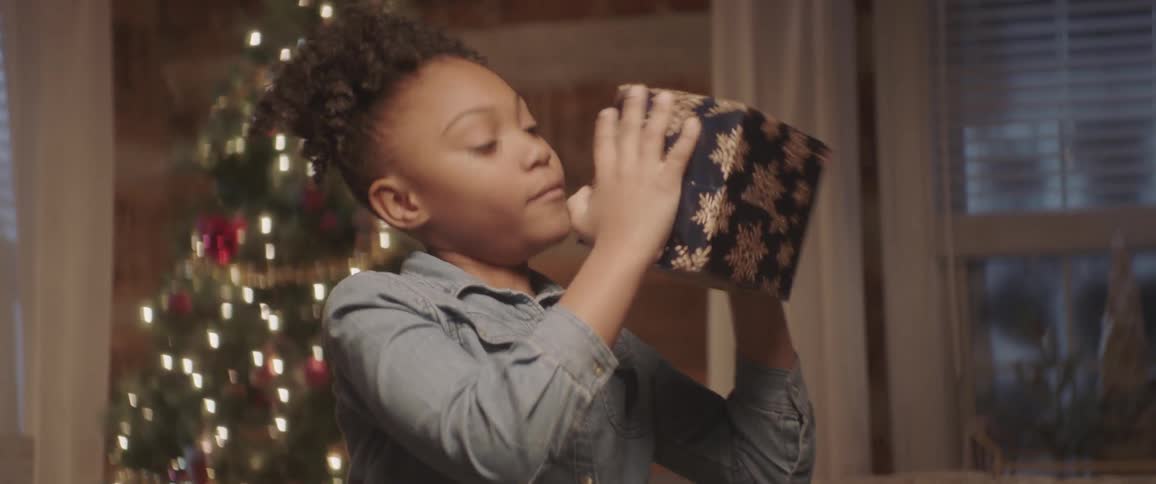 A girl shakes a present