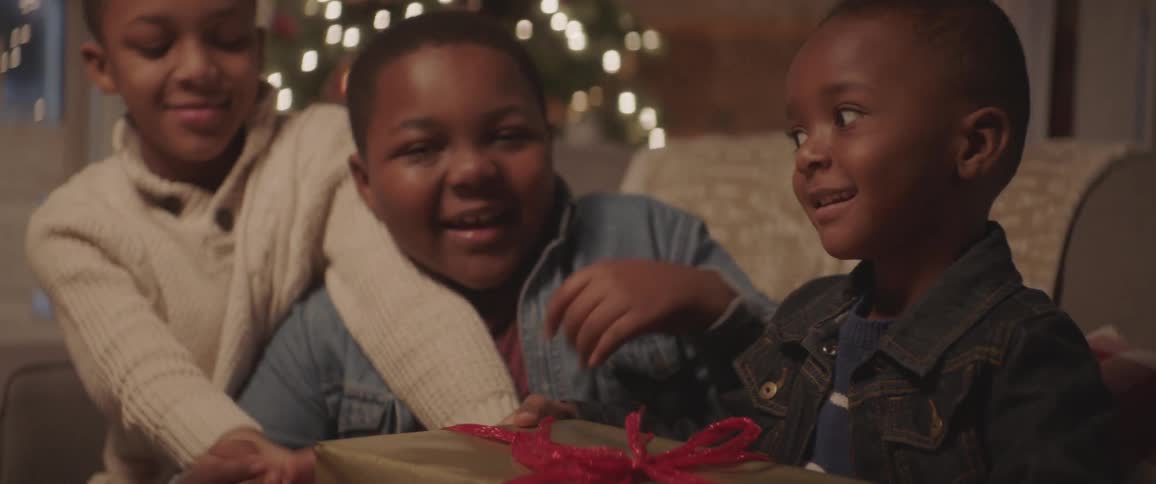 Kids play and smile as they get gifts at christmas