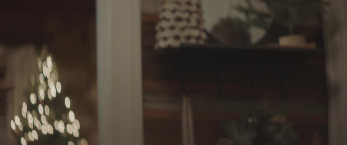 A girl bounds down the stairs with her brother to open the door