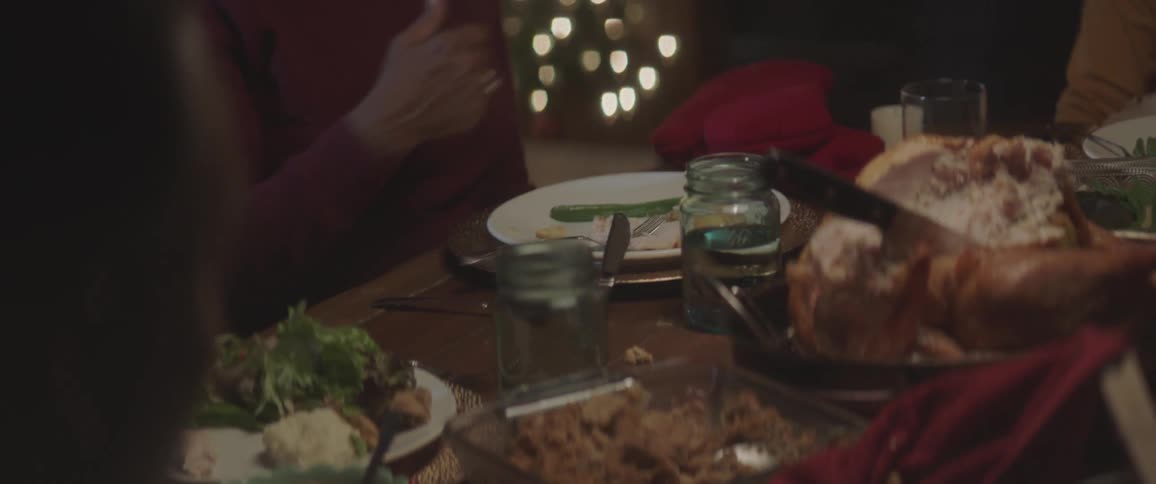 A table full of food with people sitting around it