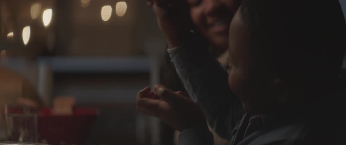 Family laughing around a label