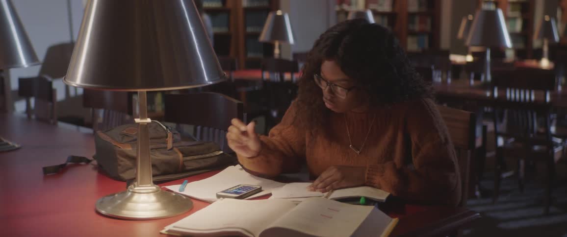 A girl studying at the library