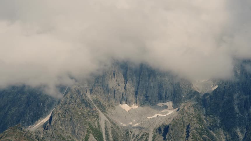 Clouds floating above a mountain top