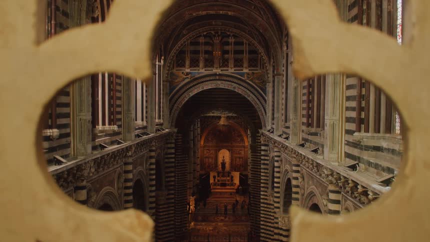Ornate walls are seen through a clover shaped keyhole