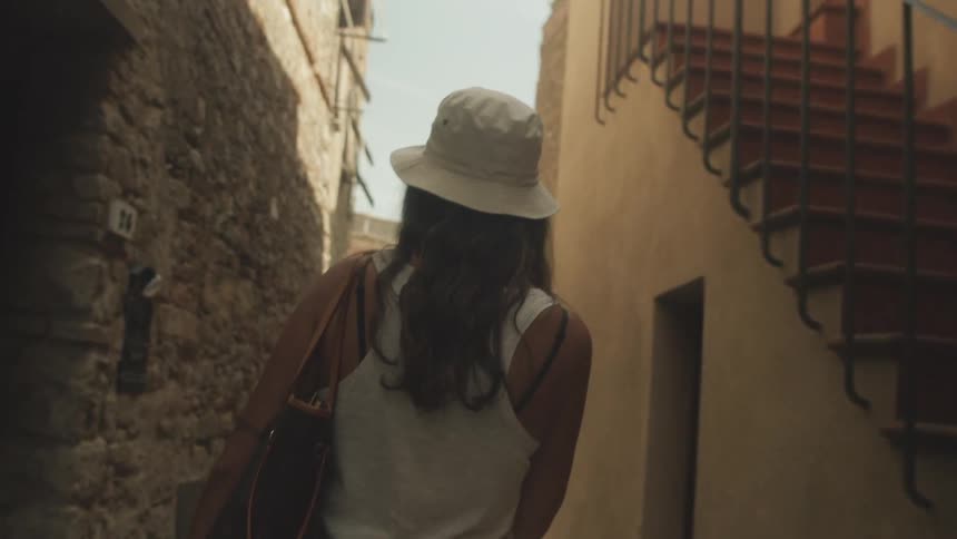 A woman is walking outside in a neighborhood