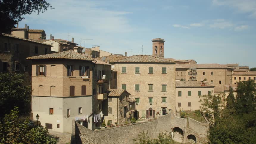 A neighborhood of closely grouped brown buildings during the day