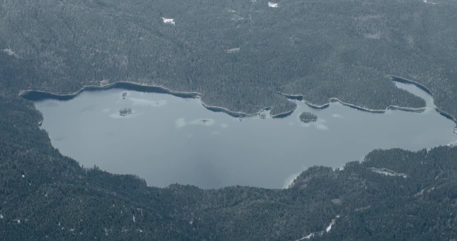An aerial view of a lake in the center of forest