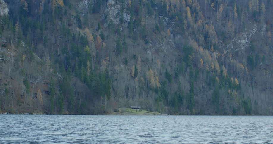 A view of a house on the mountain foot from the lake